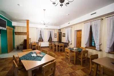 a dining room with wooden tables and chairs at Svečių namai Lingės in Nemėžis