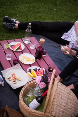 a picnic table with a basket of food and drinks at Svečių namai Lingės in Nemėžis