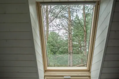 a window in a house with trees in the background at Villa Rata in Ratnyčia