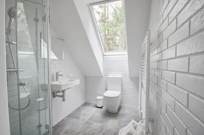 a bathroom with a toilet and a sink and a window at Villa Rata in Ratnyčia