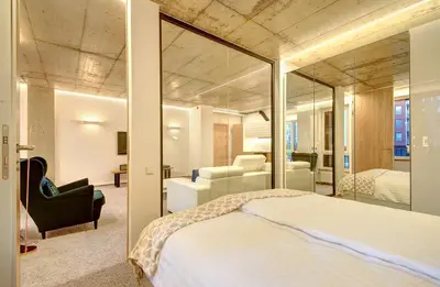 a hotel room with a large bed and a mirror at Kauno-Algirdo Luxury apartments in Vilnius