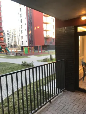 a balcony with a fence and a playground at Kauno-Algirdo Luxury apartments in Vilnius