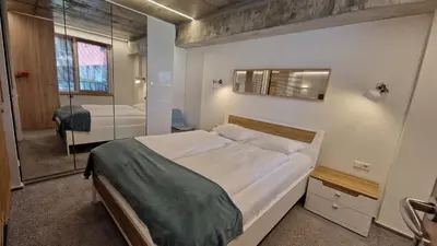 a bedroom with a large bed and a mirror at Kauno-Algirdo Luxury apartments in Vilnius