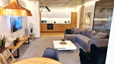 a living room with a couch and a table at Kauno-Algirdo Luxury apartments in Vilnius