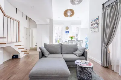 a living room with a couch and a table at 3 Bedroom Apartment 24h self check in, free parking, Ac, fireplace in Vilnius