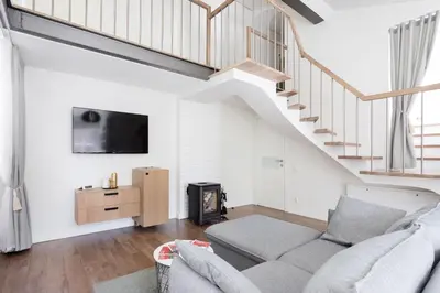 a living room with a couch and a tv at 3 Bedroom Apartment 24h self check in, free parking, Ac, fireplace in Vilnius
