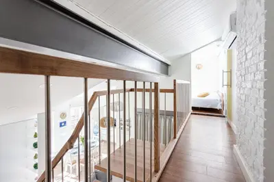 a room with a staircase leading to a bedroom at 3 Bedroom Apartment 24h self check in, free parking, Ac, fireplace in Vilnius