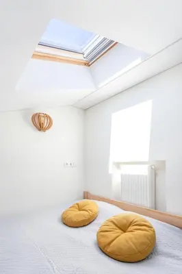 two circular bean bags on a bed in a room with a skylight at 3 Bedroom Apartment 24h self check in, free parking, Ac, fireplace in Vilnius