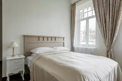 a white bedroom with a bed and a window at Vila''RADIUM'' in Druskininkai