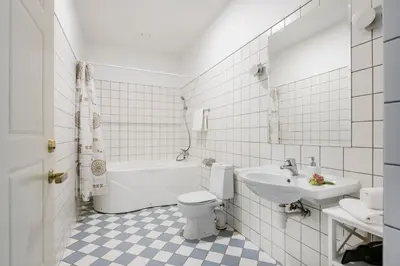 a white bathroom with a toilet and a sink at Vila''RADIUM'' in Druskininkai