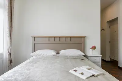 a bedroom with a large bed with two towels on it at Vila''RADIUM'' in Druskininkai