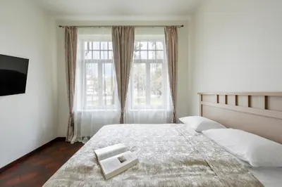 a bedroom with a bed and a large window at Vila''RADIUM'' in Druskininkai