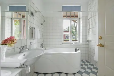a white bathroom with a tub and a sink at Vila''RADIUM'' in Druskininkai