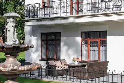 a patio with a fountain in front of a building at BURMISTRO NAMAS in Druskininkai