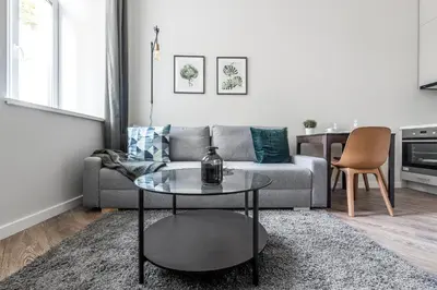 a living room with a couch and a table at City Center apartment by URBAN RENT in Vilnius