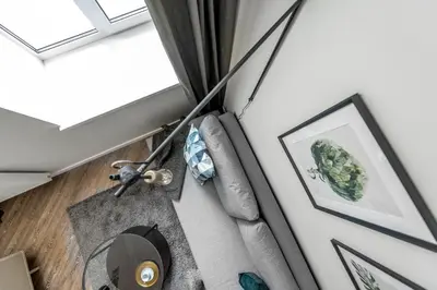 a living room with a window and a couch at City Center apartment by URBAN RENT in Vilnius