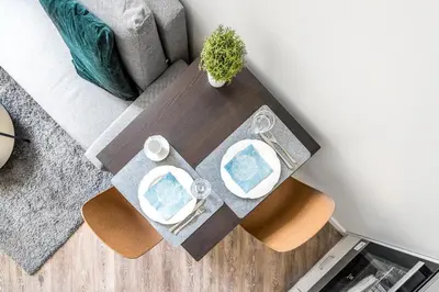 a table with two chairs and a couch at City Center apartment by URBAN RENT in Vilnius