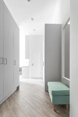 a white room with a green ottoman at City Center apartment by URBAN RENT in Vilnius