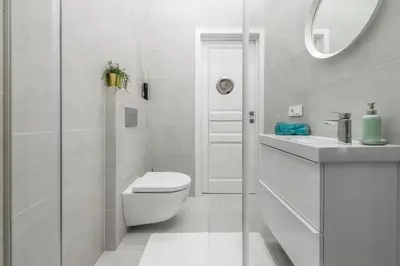 a white bathroom with a toilet and a sink at City Center apartment by URBAN RENT in Vilnius