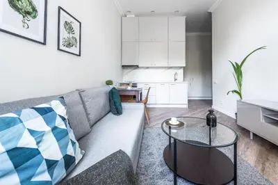 a living room with a couch and a table at City Center apartment by URBAN RENT in Vilnius