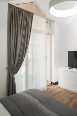 a bedroom with a bed and a window at Laurentroom Park&Fountain in Ukmergė