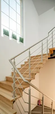 a metal staircase in a building with a window at Laurentroom Park&Fountain in Ukmergė