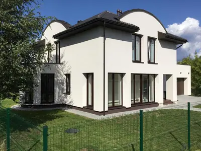 a white house with a fence in front of it at Radvi House in Druskininkai