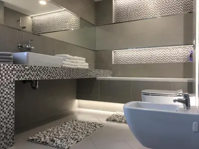 a bathroom with a white toilet and a sink at Radvi House in Druskininkai