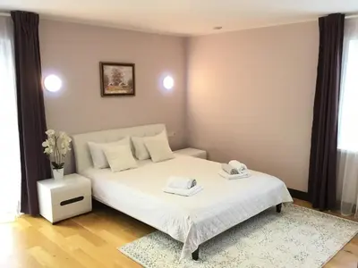 a bedroom with a white bed with two towels on it at Radvi House in Druskininkai