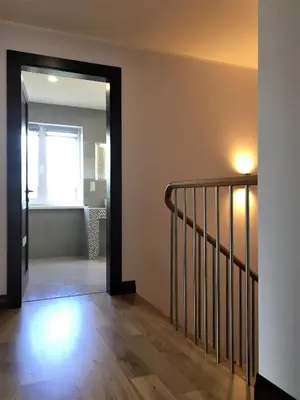 a hallway with a door leading to a stairway at Radvi House in Druskininkai