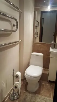 a bathroom with a white toilet and a mirror at Apartamentai Dainų II in Šiauliai
