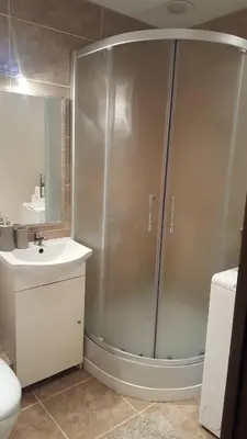 a bathroom with a shower and a sink at Apartamentai Dainų II in Šiauliai