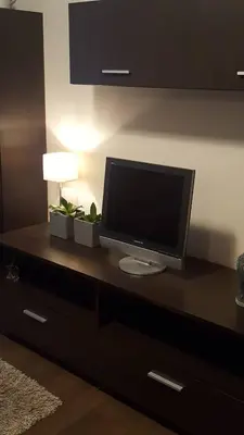 a flat screen tv sitting on top of a dresser at Apartamentai Dainų II in Šiauliai