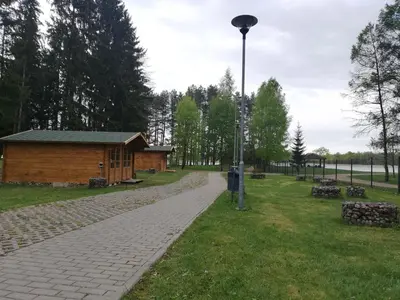 a light pole next to a building in a park at Biržai camping in Biržai