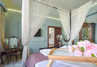 a bedroom with a bed with two wine glasses and roses at Inner Blossom in Kaunas