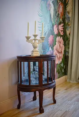 a candle holder on a table with three candles on it at Inner Blossom in Kaunas