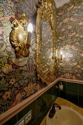 a bathroom with a gold mirror and a sink at Inner Blossom in Kaunas