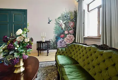 a living room with a green couch and flowers at Inner Blossom in Kaunas