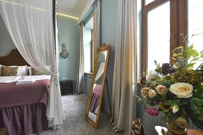 a bedroom with a bed and a mirror and flowers at Inner Blossom in Kaunas