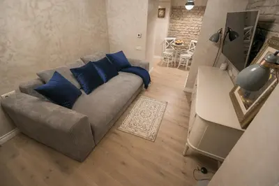 a living room with a couch and a table at Luxury apartment in Pilies street in Vilnius