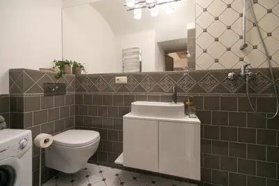 a bathroom with a toilet and a sink and a mirror at Luxury apartment in Pilies street in Vilnius