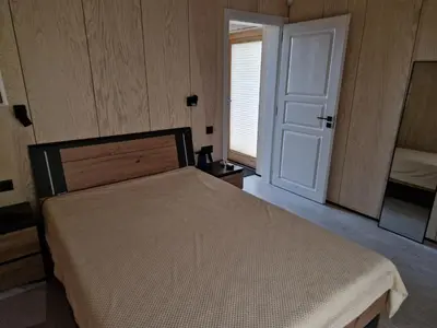 a bedroom with a bed and a window and a door at Aido ir Vido sodyba in Utena