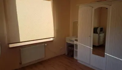a room with a window and a white cabinet at Kambario nuoma su bendru vonios kambariu in Kaunas