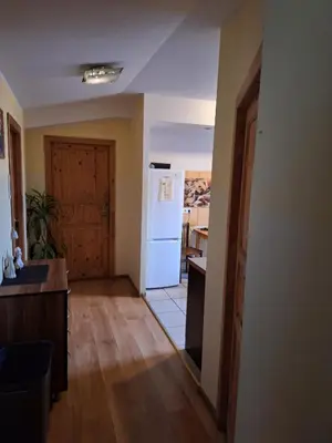 a kitchen with a white refrigerator and a table at Kambario nuoma su bendru vonios kambariu in Kaunas