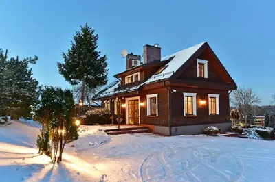 a house in the snow with lights on at Spa Villa Trakai in Trakai