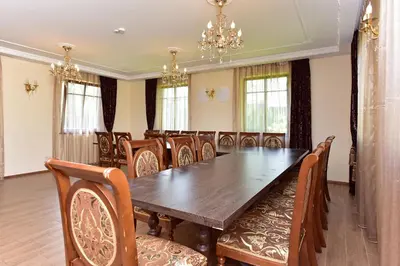 a dining room with a wooden table and chairs at Spa Villa Trakai in Trakai