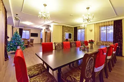 a dining room with a table and a christmas tree at Spa Villa Trakai in Trakai