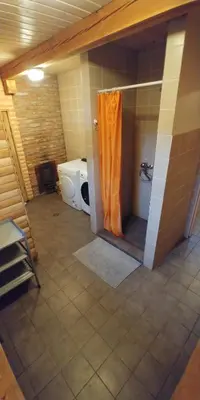 a bathroom with a shower with an orange shower curtain at Antanelio Sapnas in Pabradė