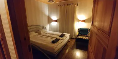 a small bedroom with a bed and a chair at Antanelio Sapnas in Pabradė