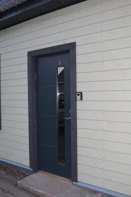 a blue door of a building with a mirror at Old Slabada Apartments in Kaunas